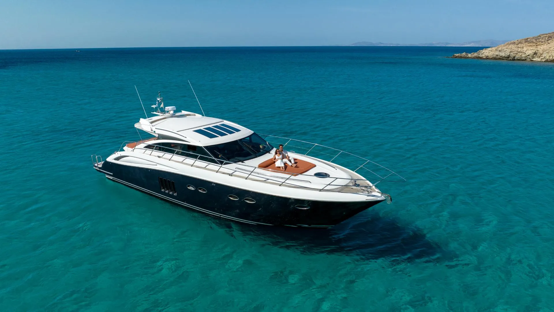 Aerial view of luxury yacht in crystal clear turquoise waters of Greece
